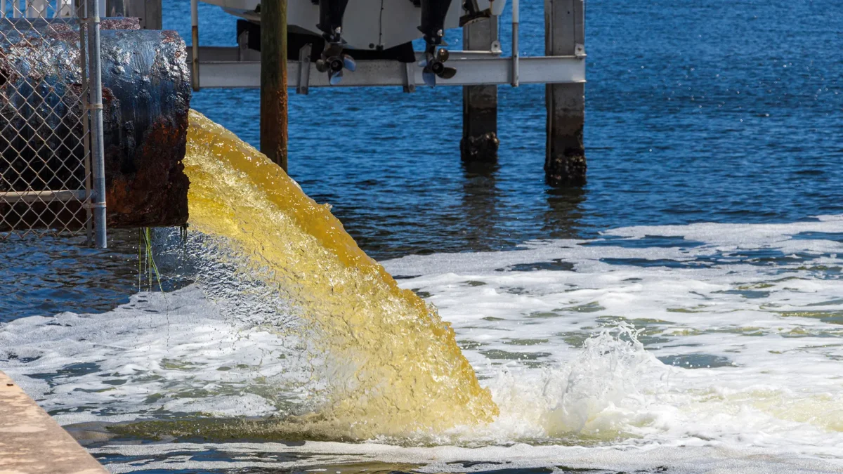 Sewage being pumped into a blue lake